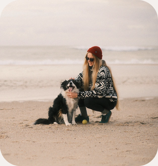 Ira with her dog on the beach